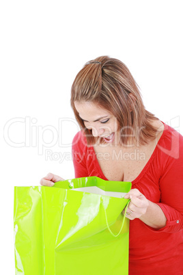 surprised brunette woman holding opened shopping bag