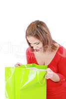 surprised brunette woman holding opened shopping bag