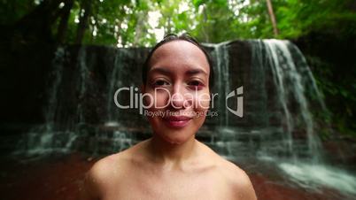 Tribal girl in jungle waterfall