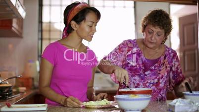 Mother daughter preparing meal together