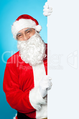 Santa posing beside long blank banner ad