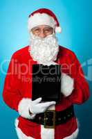 Father Christmas presenting a new tablet device