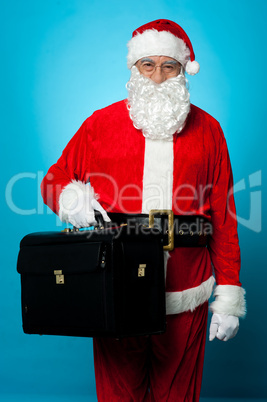 Santa is all set to visit his new office, holding briefcase