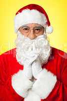 Thoughtful Santa Claus wearing eyeglasses