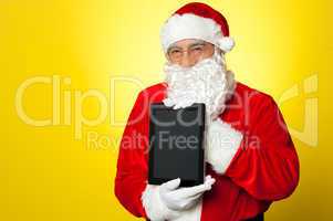 Santa Claus holding newly launched tablet device