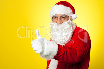 Santa showing thumbs up gesture to camera