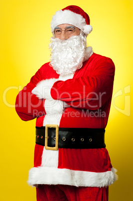 Confident male Santa posing with arms folded