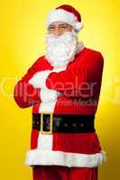 Confident male Santa posing with arms folded