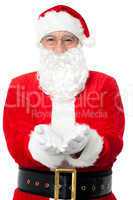 Bespectacled Father Santa posing with open palms