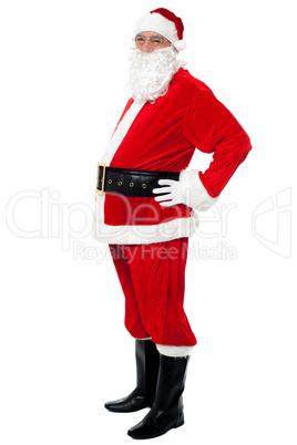 Confident Santa with a big belly posing sideways