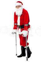Santa walking with the help of crutches