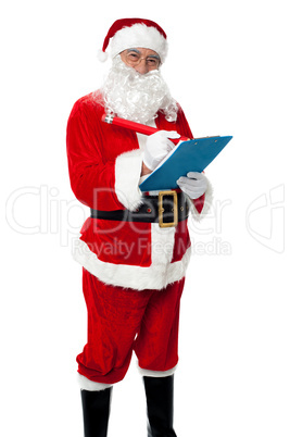 Santa Claus making list of gift recipients