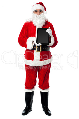 Saint Nicholas displaying a brand new tablet device