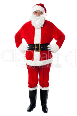 Cheerful Santa Claus posing with hands on waist