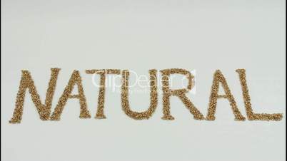 Natural written with wheat kernels