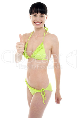 Glamorous bikini model showing thumbs up