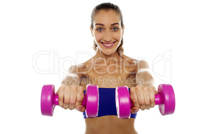 Lady lifting dumbbells, arms outstretched