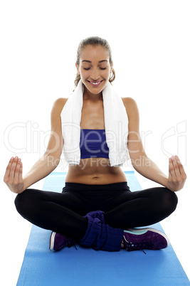 Attractive brunette meditating in lotus posture