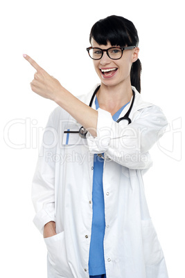 Cheerful physician pointing away, copy space area