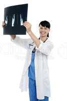 Young surgeon holding x-ray sheet of a patient
