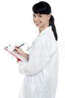 Nurse writing fresh prescription for the patient