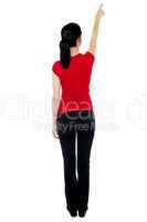 Back pose of woman in casuals pointing away