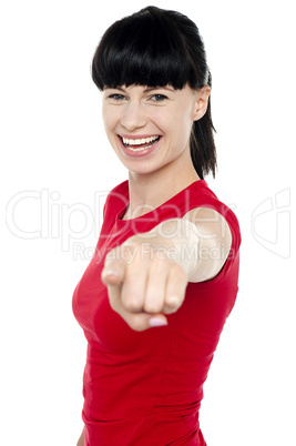Attractive cheerful woman pointing at you