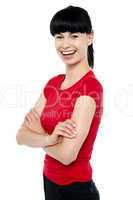 Pretty slim lady in bright red top, arms folded