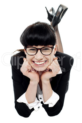 Woman relaxing on floor with hands on her cheeks