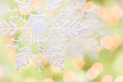 Snowflake Over an Abstract Green and Gold Background