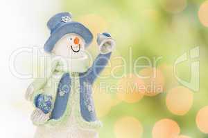 Snowman Statue On Snow Over a Blurry Abstract Background