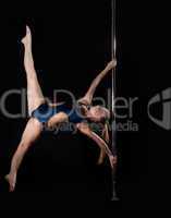 Strong pole dance woman in costume