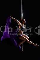 Pretty pole dance woman with purple fabric