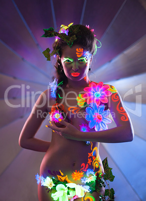 Beauty woman with glowing make-up posing in dark
