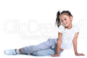 Asian little girl in sportswear sitting on floor