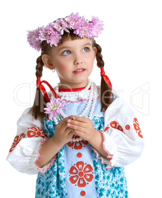 cute Little girl in slavic costume and wreath