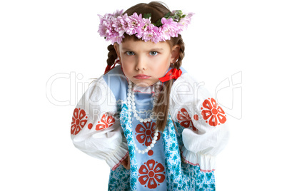 Funny little girl in slavic costume and wreath