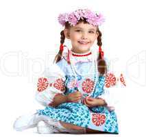 Happy little girl in slavic costume and wreath