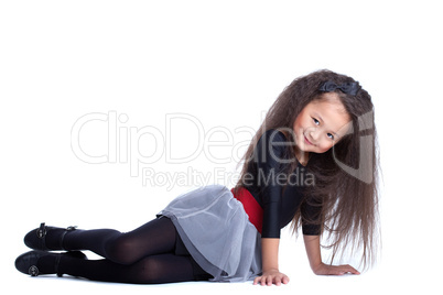 Fashion little girl sitting on floor
