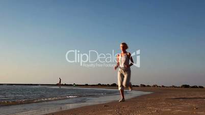 Girl jogging along a Beach