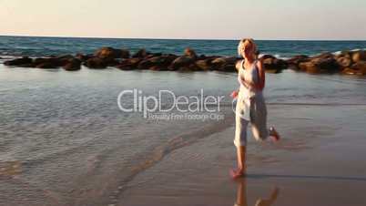 Girl jogging along a Beach