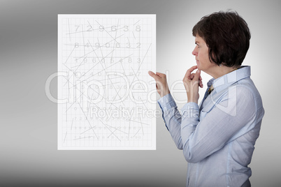 Woman looks thoughtfully at a poster