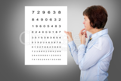 Woman looks thoughtfully at a poster