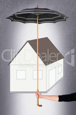 Hand holding umbrella over house