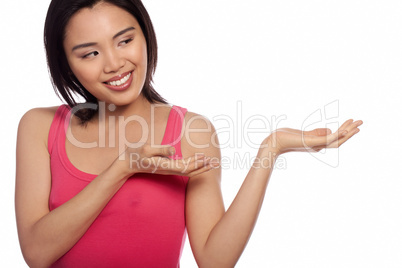 Smiling Asian woman holding out her palm