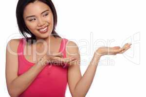 Smiling Asian woman holding out her palm