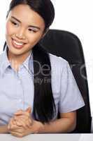 Asian businesswoman seated at her desk