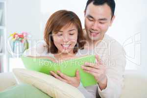Asian couple reading book