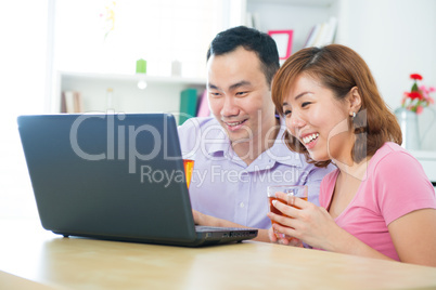 Asian couple using notebook