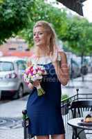 a beautiful young girl in summer dress with a bunch of flowers